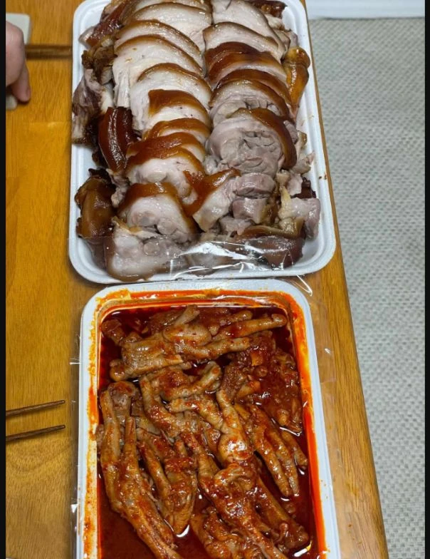 Takeaway containers of sliced jokbal and chicken feet in red sauce from Ilho Jokbal.