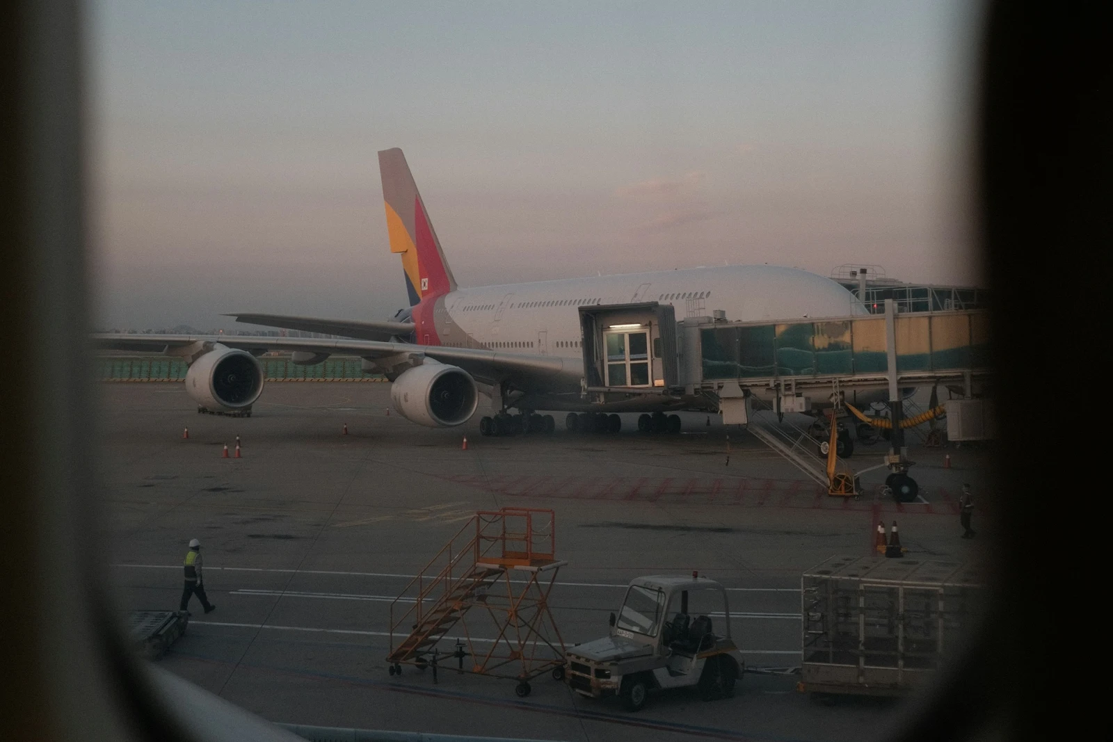 An aircraft at a gate in Incheon, viewed through an airplane window