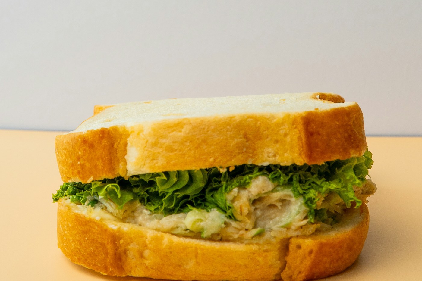 Illustrative savory sandwich on sliced bread; actual convenience-store fillings and products vary.
