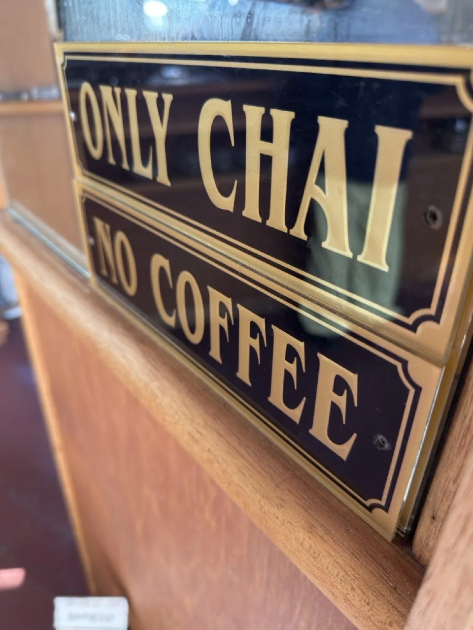 Gold-lettered signs at Noppensan reading “Only chai, no coffee.”