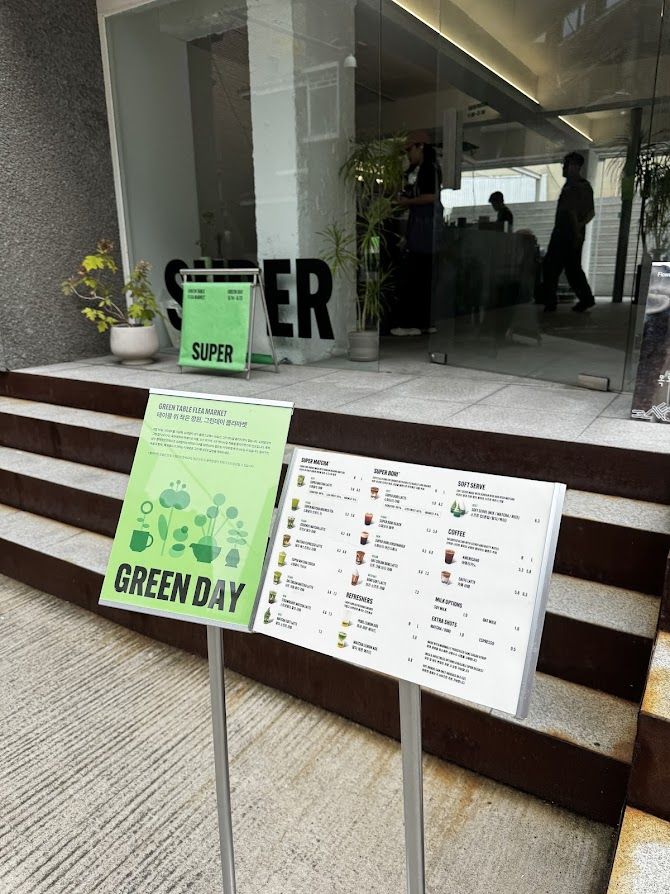 SUPER MATCHA Seongsu entrance with concrete steps, bold SUPER lettering and green signage.